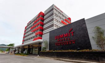 a large hotel building with a red and white exterior , located on a street in a city at Summit Hotel Tacloban