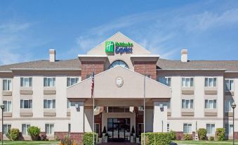 "a large hotel with a sign that reads "" holiday inn express "" prominently displayed on the front of the building" at Home2 Suites by Hilton Ogden