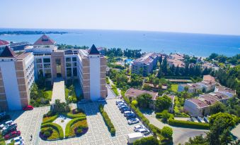a bird 's eye view of a city with a large building and ocean in the background at Horus Paradise Luxury Resort - All Inclusive