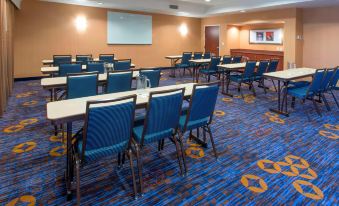 a conference room with blue carpet , chairs , and tables arranged for a meeting or training session at Courtyard by Marriott Montgomery Prattville