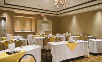 a large conference room with tables and chairs set up for a meeting or event at Hilton Garden Inn Phoenix Airport North