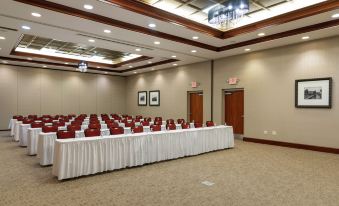 a large , empty conference room with rows of chairs and tables set up for a meeting or event at Hilton Garden Inn Columbus/Edinburgh