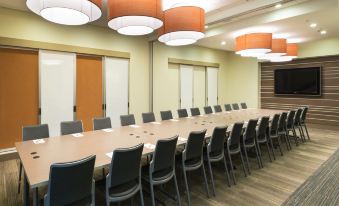 a large conference room with a long table and chairs arranged for a meeting or event at Even Hotel Rockville - Washington, DC Area, an IHG Hotel