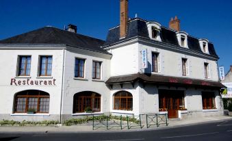 "a white building with a sign that reads "" le restaurant "" is shown in the image" at Hotel Saint-Hubert
