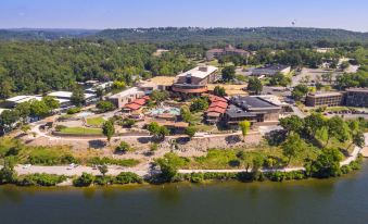 a bird 's eye view of a large building complex with a river and trees in the background at Lodge of Four Seasons Golf Resort, Marina & Spa