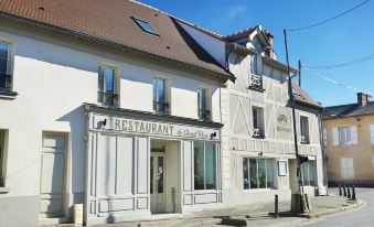 a two - story building with a restaurant sign on the front , located in a residential area at Hob le Cheval Blanc