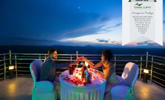 "a man and a woman are enjoying a romantic dinner on a balcony overlooking the ocean , with the date "" october 1 9 "" visible" at Coorg Cliffs Resort