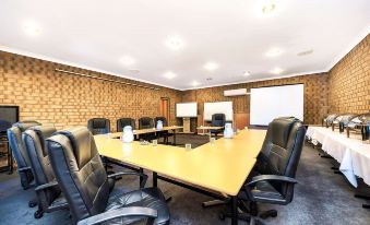 a large conference room with a wooden table and multiple chairs arranged around it , creating a meeting space at Comfort Inn & Suites Sombrero