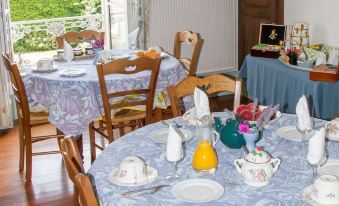 a dining room with a table set for breakfast , complete with plates , cups , and utensils at Chez Pierre