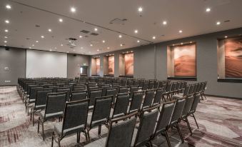 a large conference room with rows of chairs arranged in a semicircle , ready for an event at Courtyard Ciudad Juarez