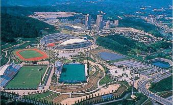 an aerial view of a large stadium surrounded by buildings and a city in the background at Hotel Hokke Club Hiroshima