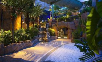 a well - lit indoor water park with various water features and plants , creating a relaxing atmosphere at Scandic the Reef