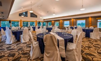 a large dining room with multiple round tables and chairs , all set up for a formal event at Best Western Plus Valemount Inn  Suites
