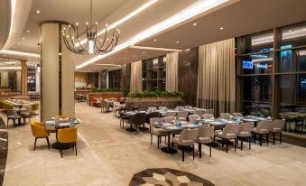 a large , modern restaurant with multiple dining tables and chairs , creating a comfortable atmosphere for guests at Hilton Mall of Istanbul