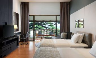 a modern hotel room with two beds , a tv , and a balcony view , all set against a backdrop of trees at Le Meridien Chiang Rai Resort, Thailand
