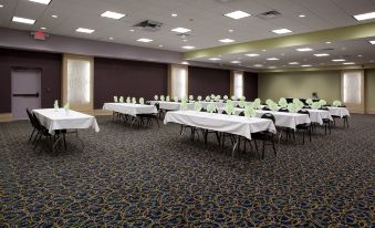 a large conference room with rows of tables and chairs set up for a meeting or event at Holiday Inn Rock Springs