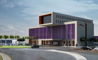 a modern building with a purple exterior and large windows is shown in an artist 's rendering at Hilton Garden Inn Monterrey Airport