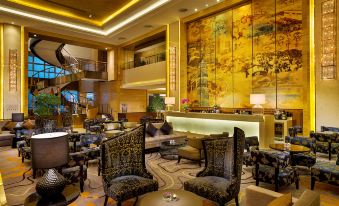 The hotel has a spacious lobby or restaurant area with tables and chairs where guests can dine and relax at Expo Center Hotel