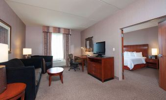a hotel room with a comfortable bed , a flat - screen tv , a desk , and a chair at Hilton Garden Inn Columbus/Edinburgh