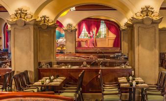 A dining area in an old-fashioned restaurant or bar with tables and chairs at Shanghai Disneyland Hotel
