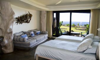 a room with two beds , one on the left side and the other on the right side at Nayara Hangaroa