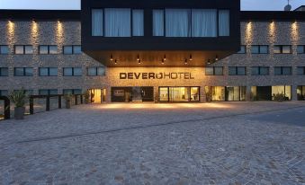 "a large hotel building with a stone exterior and the name "" devero hotel "" on the front" at Devero Hotel  Spa, BW Signature Collection