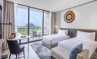 a modern hotel room with two beds , a large window , and a colorful artwork on the wall at Gran Melia Arusha