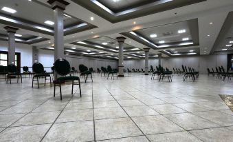 an empty banquet hall with rows of tables and chairs , ready for a gathering or event at Costa Bahia Hotel, Convention Center and Casino