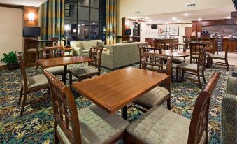 a large dining room with several tables and chairs , some of which are made of wood at Staybridge Suites Milwaukee Airport South