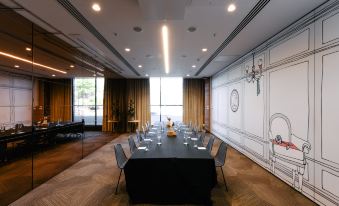 a large conference room with a long table and chairs arranged for a meeting or event at Ovolo Woolloomooloo