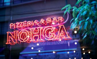 "a neon sign for a bar called "" pizzeria & bar sohga "" is lit up on a building" at Nohga Hotel Akihabara Tokyo