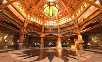 a large wooden ceiling with a stained glass window , allowing natural light to fill the space at Four Winds Casino Resort – New Buffalo