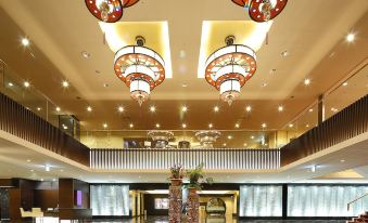 a large hotel lobby with multiple chandeliers hanging from the ceiling , creating a grand atmosphere at Grand Mercure Lake Hamana Resort & Spa