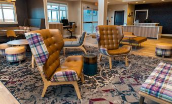 a cozy living room with several chairs and a couch arranged in a seating area at Residence Inn Upper Marlboro Joint Base Andrews