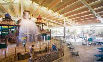 an indoor water park with multiple water slides and attractions , as well as people enjoying themselves in the water at Great Wolf Lodge Grapevine