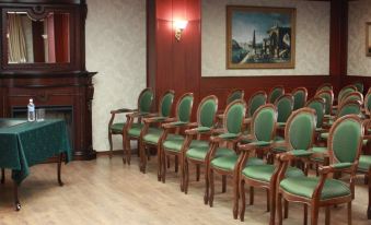 a conference room with rows of green chairs and a table set up for an event at Parus