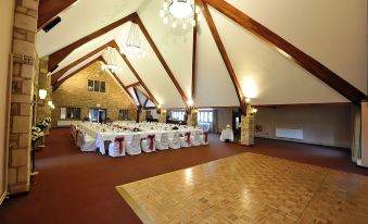 a large room with a dance floor and tables set up for a formal event at The Frogmill Hotel