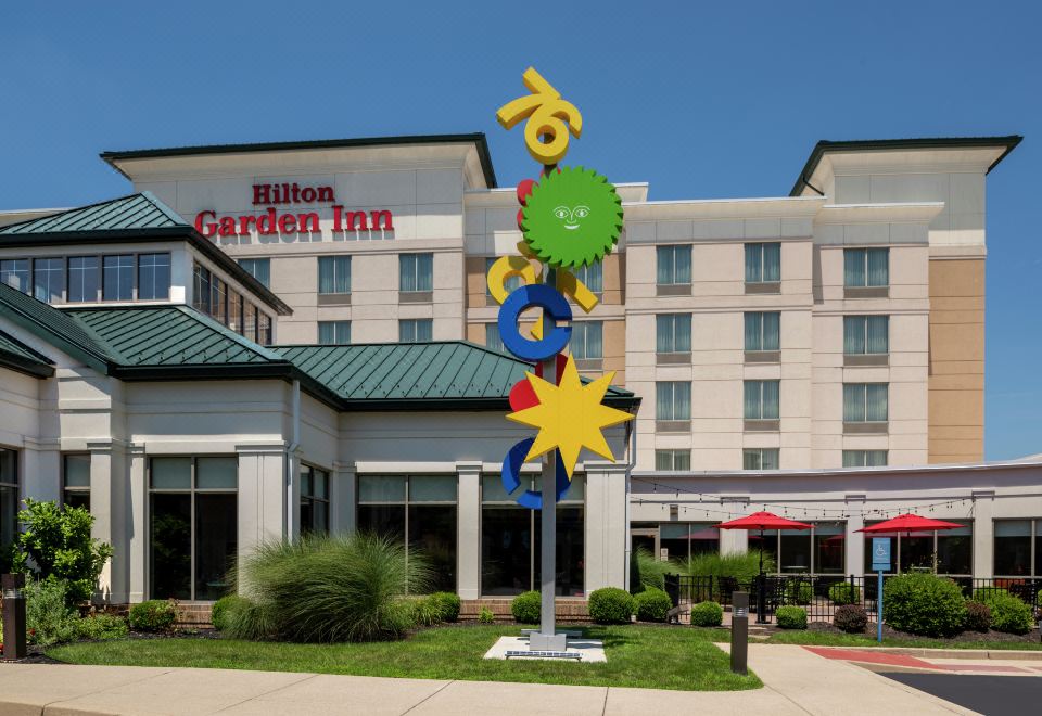 a hilton garden inn hotel with its sign and entrance , surrounded by grass and trees at Hilton Garden Inn Columbus/Edinburgh