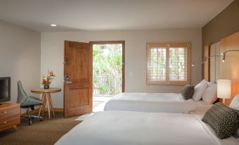 a room with two beds , one on the left and one on the right side of the room at Catalina Canyon Inn