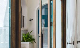 a room with two sliding glass doors , one on the left and the other on the right at Santarena Hotel at Las Catalinas