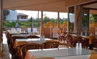 a restaurant with a large dining area , tables , chairs , and a view of the outdoors at Palladion