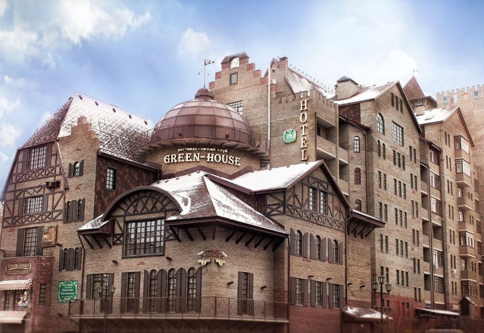 "a large building with a sign that says "" greenhouse "" and a domed roof , surrounded by snow" at Green House