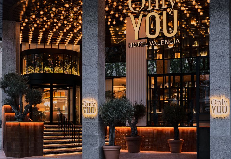 "a nighttime scene of a hotel entrance with a sign that reads "" only you "" above the door" at Only You Hotel Valencia