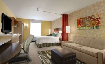 a hotel room with a bed , couch , and chair , as well as a dining table at Home2 Suites by Hilton Oxford