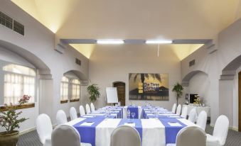 a large , well - lit conference room with a long table and multiple chairs arranged for a meeting at Three Corners Rihana Resort El Gouna