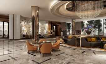 a luxurious hotel lobby with a marble floor , a large chandelier , and several chairs arranged around a coffee table at Hilton Mall of Istanbul