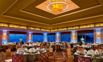 a large , well - lit banquet hall with multiple dining tables set up for guests to enjoy a meal at The Westin Playa Bonita Panama