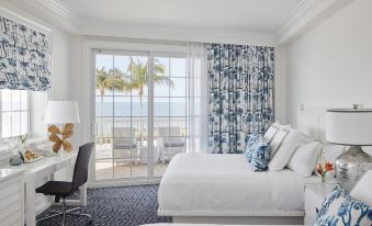 a hotel room with two beds , a window overlooking the ocean , and a desk near the window at Isla Bella Beach Resort & Spa - Florida Keys