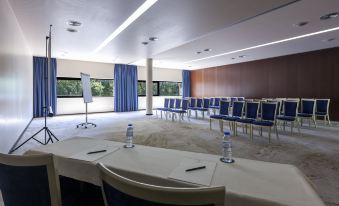 a conference room with rows of chairs and tables , each set up for a meeting at Douro Palace Hotel Resort & Spa