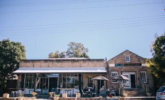 "a brick building with a sign that reads "" long branch coffee shop "" on it , located in a small town" at Terroir Auburn
